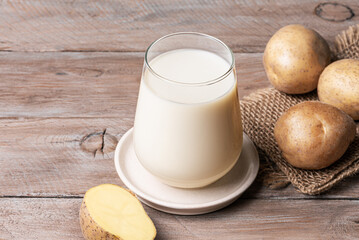 Vegan potato milk on wooden background