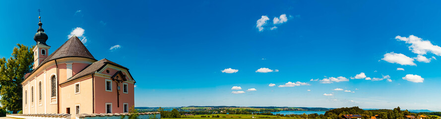 Fototapeta premium High resolution stitched panorama of an alpine summer view with a church near Lake Waging, Waging am See, Traunstein, Bavaria, Germany
