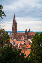 Germany, Nice view to freiburg im breisgau city houses skyline downtown minster cathedral church old town tourism destination between green trees