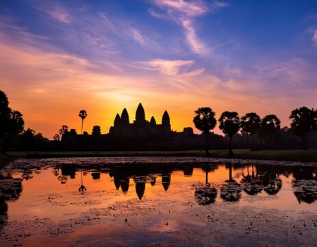 angkor wat highly detailed silhouette during sunrise vibrant sky ancient stone carvings - Powered by Adobe