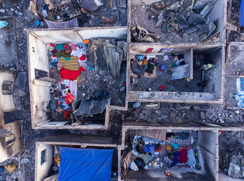 Dhaka, Bangladesh - 28 November 2025: Aerial view of stark, burnt-out rooms reveal intimate glimpses of lives disrupted, contrasting sharply with the harsh reality of their surroundings.