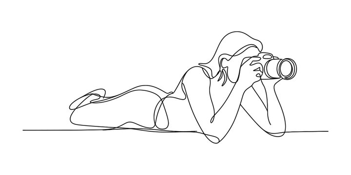 Continuous line art of a woman lying down and taking a photograph with a professional camera Vector, illustration