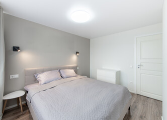 Minimalism Bedroom Interior. Wardrobe in Background. Coffee Table and Light. Windows and Curtains. Home.