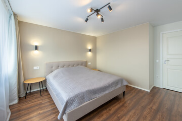Minimalism Bedroom Interior. Wardrobe in Background. Coffee Table and Light. Windows and Curtains. Home.