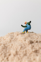 Small Figure Surfing Sand