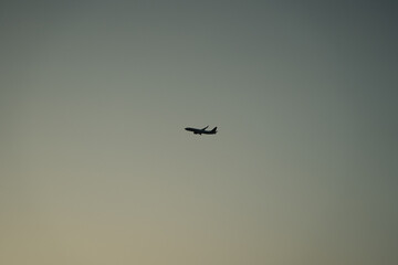 Airplane silhouette in minimal sky