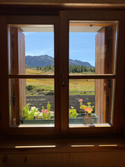 Fototapeta premium the beautiful Alpine landscape seen from the window of a chalet