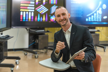 Caucasian businessman with digital tablet working in business meeting room