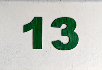 Number thirteen on white surface