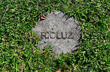 Municipal Energy and Lighting Company (RIO LUZ) logo engraved in cement on the grass, Rio de Janeiro, Brazil
