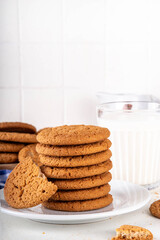 Homemade golden-brown Gingersnap Cookies stack on kitchen table. Traditional american ginger snap cracked biscuit cookies, with milk glass, copy space