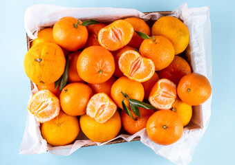 Fresh tangerines, mandarin clementines, raw farm organic citrus fruits, with stems and leaves, for sale at market 