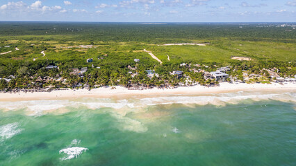 Tulum Beach, Quintana Roo, Mexico, Beautiful beach with a green forest in the background. The ocean is calm and the sky is clear