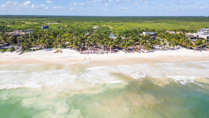 Tulum Beach, Quintana Roo, Mexico, Beautiful beach with palm trees and a clear blue ocean. The beach is full of people enjoying the sun and the water