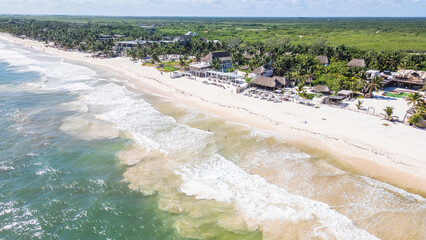 Tulum Beach, Quintana Roo, Mexico, Beach with a greenish tint to the water. The beach is empty and the sky is clear