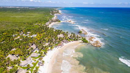 Tulum Beach, Quintana Roo, Mexico, Beautiful beach with palm trees and a clear blue ocean. The beach is full of people enjoying the day