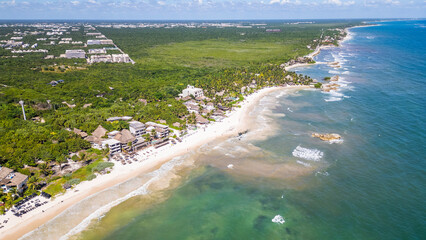 Tulum Beach, Quintana Roo, Mexico, Beautiful beach with palm trees and a clear blue ocean. The beach is full of people enjoying the day