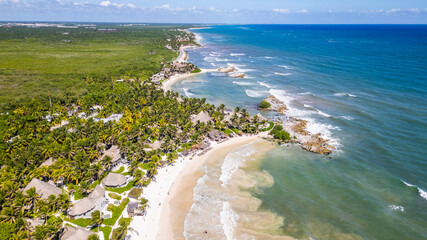 Tulum Beach, Quintana Roo, Mexico, Beautiful beach with palm trees and a clear blue ocean. The beach is full of people enjoying the day