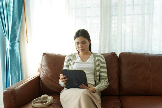 Woman working remotely on laptop while relaxing at home terrace