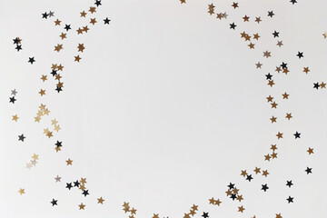 Metallic gold, silver black star confetti circle isolated on white background. Festive celebration round frame. Birthday party decoration border. Holiday New Year composition, copyspace, flatlay, top