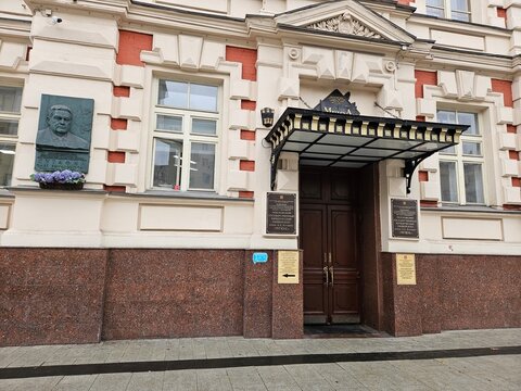 MOSCOW - OCT 29, 2024: Building University of Law with a statue of a man Kutafin on the front. The building has a blue sign The object is guarded on the front