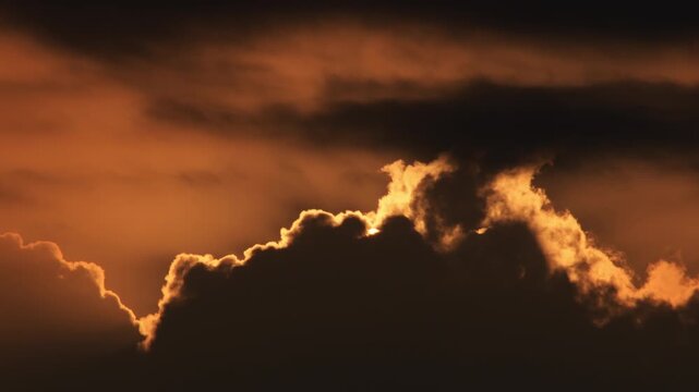 Clouds at sunset passing with the sun. Time Lapse