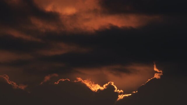 Clouds at sunset passing with the sun. Time Lapse