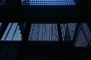 A blue stainless steel perforated sheet metal background. 