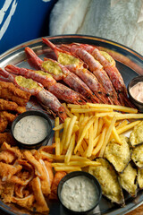 A vibrant seafood platter showcases juicy shrimp and crispy fried seafood, accompanied by golden fries and flavorful dipping sauces, inviting all to indulge in this culinary delight
