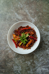 Steaming stir-fried noodles adorned with colorful peppers, green onions, and juicy chicken pieces create an appetizing feast perfect for sharing. Enjoy this flavor-packed dish any time of day