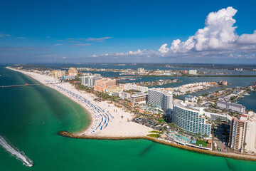 Fototapeta premium Panorama of city Clearwater Beach FL. Spring, winter or summer vacations in Florida. Beautiful View on Hotels and Resorts on Island. Blue-Turquoise of Ocean water. Gulf of Mexico or America. Sunny day