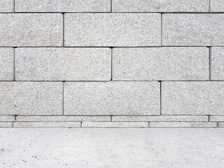 Grey brick wall with sidewalk. Empty background