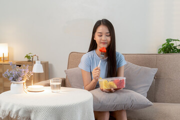 Woman enjoying fresh fruit at home
