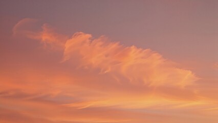 Fototapeta premium Clouds in the sky during sunset with warm tones and soft light. Nature and atmospheric scene. Sky and weather phenomena. The concept of natural beauty and sky views