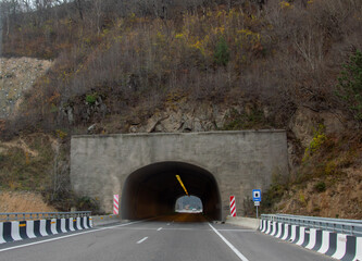 Autumn road in the mountains. Entering a tunnel.