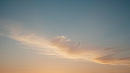 A clear sky with wispy clouds during sunset or sunrise.