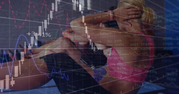 Cue starting group on mats, lead woman twisting while finance overlay shifting focus for core