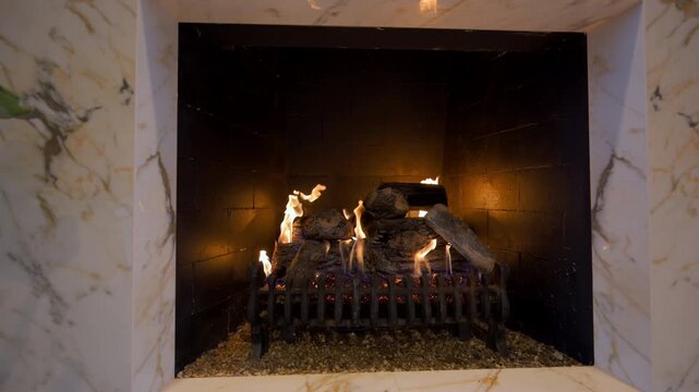 Fireplace with the burning woods. Fire in the fireplace. A cozy place to relax. Fire and firewood as background. Burning wood in the furnace. Fire video