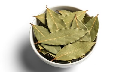 A small white bowl filled with dried bay leaves isolated on a white background, a common cooking ingredient