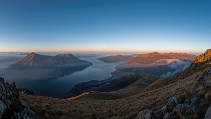 Scenic view of a lake surrounded by mountains at sunset. Nature and landscape photography, scenic and tranquil environment, peaceful and beautiful scenery.