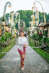 Balinese Woman in Traditional Attire at Penglipuran Village During Galungan