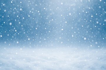 Winter snowfall background with snowflakes falling in blue atmosphere