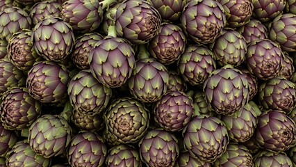 Close-up of fresh purple artichokes piled together showing textured leaves and natural color variation
