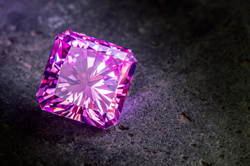 A large purple diamond is sitting on a grey surface