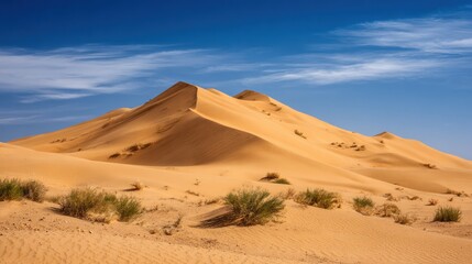 Golden Desert Sand Dunes Under Blue Sky in Arid Landscape