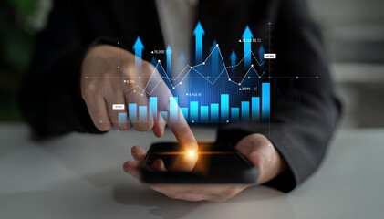 A businesswoman focuses on her smartphone with interactive graphs and charts. This image symbolizes financial analysis, investment tracking, and data-driven decisions for professionals. Scalp