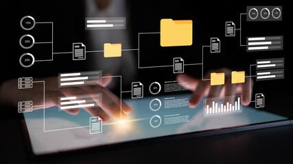 Close-up of hands interacting with a tablet featuring digital representations of data with charts and file organization, symbolizing modern technology and data management solutions. Gantry