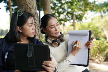 Asian women engage in recreational activities in a park.