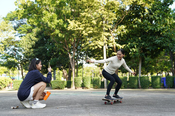 Asian women engage in recreational activities in a park.