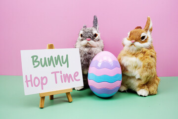 Bunny Hop Time text with rabbit and egg on pink and green background